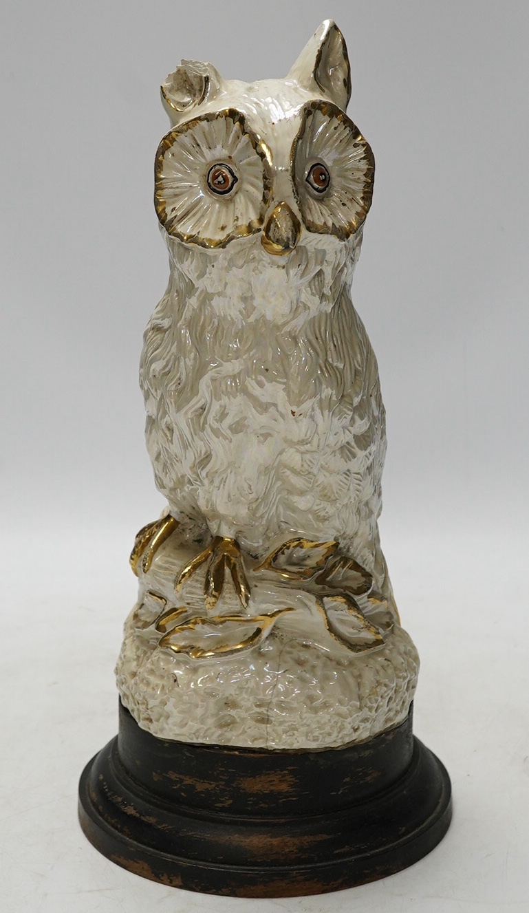 From the Studio of Fred Cuming. A ceramic lustre owl raised on circular base. Condition - (a.f.)